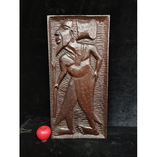 117 - A heavy hand carved African wood panel artwork. Features a tribal leader.