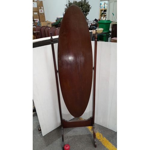 606 - Star Lot : A very handsome Edwardian mahogany cheval bevelled mirror with oval glass. Supported by e... 