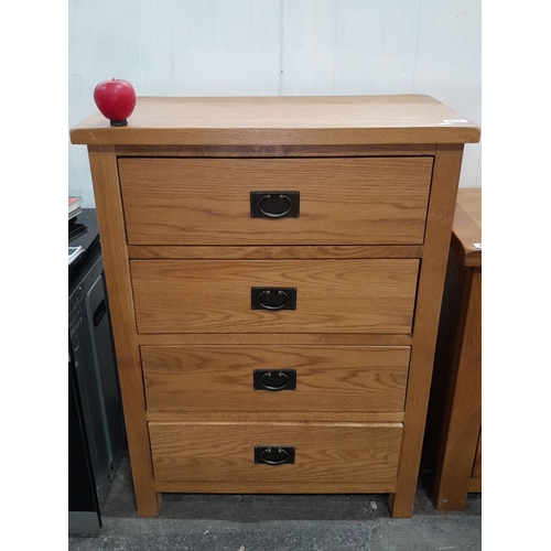 619 - A solid Oak chest of drawers with four drawers, featuring metal handles.