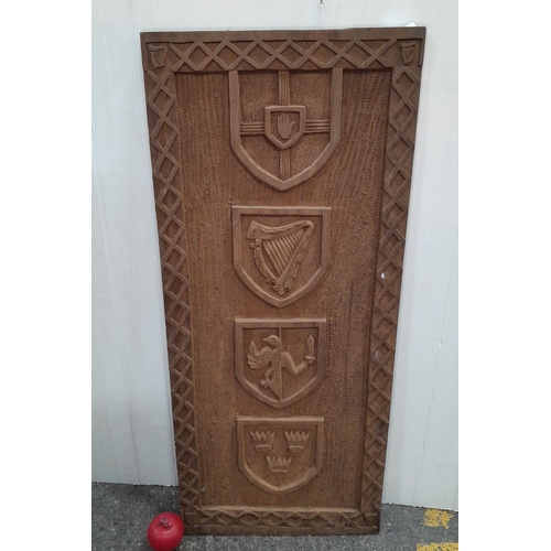 620 - Hand-carved Irish wooden panel featuring four heraldic shields with intricate details, possibly depi... 