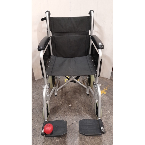 634 - Drive DeVilbiss lightweight aluminum transport wheelchair. Black upholstery and flip-up footrests ar... 