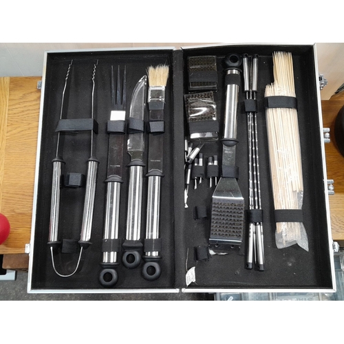 648 - Steel barbecue tool set in a silver carrying case. Includes tongs, fork, knife, brush, skewers, and ... 