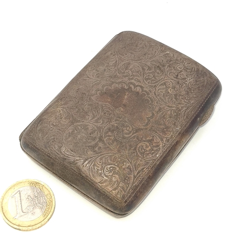 511 - An antique sterling silver cigarette case. Hallmarked Birmingham. Set with foliate detailing and gil... 