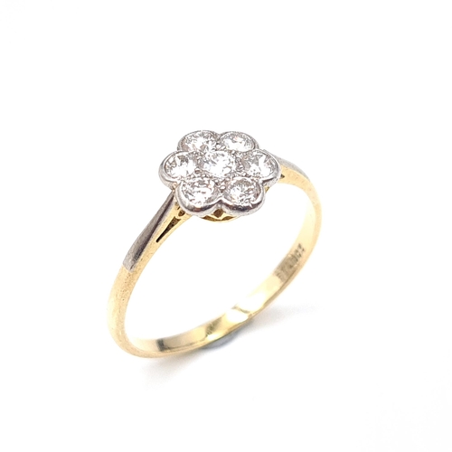 516 - Star Lot: An 18 carat gold and platinum ring with diamond daisy cluster setting. Estimated weight of... 