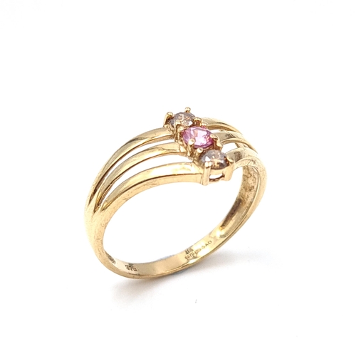 517 - Star Lot: A nine carat gold diamond and pink sapphire stone ring. Size O. Weight 2.19 grams. A most ... 