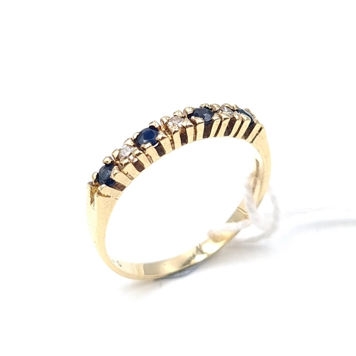 521 - Star Lot: A pretty example of a nine carat gold sapphire and diamond ring. Size N. Weight 1.7 grams.