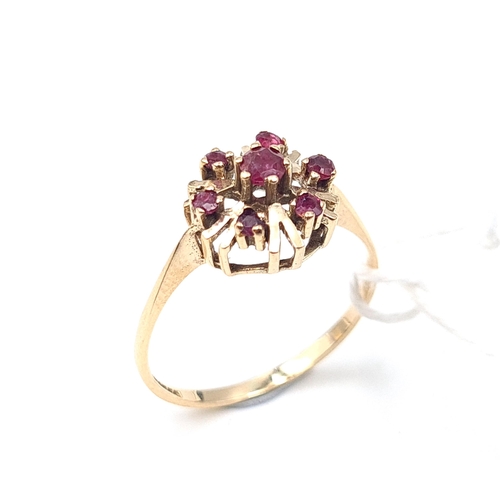 522 - Star Lot: A nine carat gold ruby cluster ring. Size P. Weight 1.65 grams.