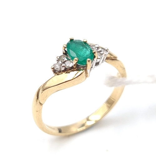 525 - Star Lot : A nice example of an emerald and diamond set ring. Mounted in nine carat gold. Ring size ... 