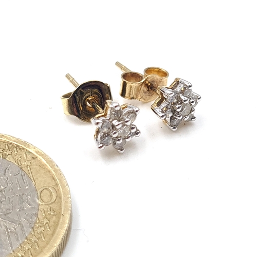 526 - A pair of nine carat gold diamond set stud earrings. Weight .96 grams.