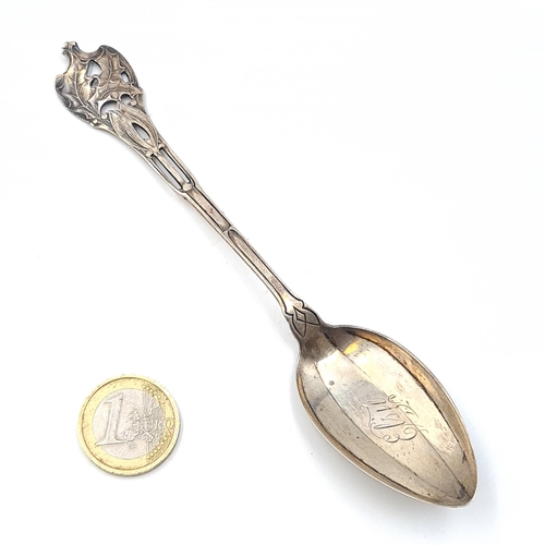 534 - A sterling silver spoon. Hallmarked Sheffield with attractive leaf designed finial. Features an insc... 