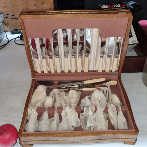 394 - A vintage Newbridge cutlery canteen housed in a smart walnut travel case. Comprises of knives, forks... 