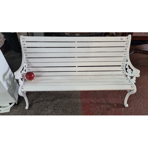 701 - A neat site possibly Childs White wooden bench with ornate cast iron sides, featuring a classic slat... 