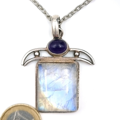 558 - An antique sterling silver mount pendant set with Lapis Lazuli and large moon stone setting. Dimensi... 