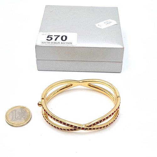 570 - A rhinestone twist set bangle by the maker Monet. Boxed.