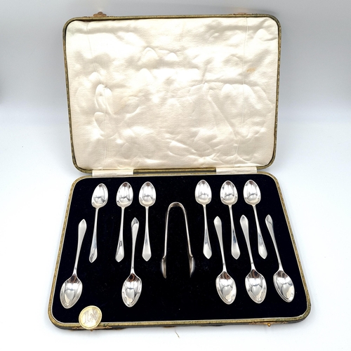 588 - A very nice example of an 11 piece silver plated tea spoon set together with a pair of sugar tongs. ... 