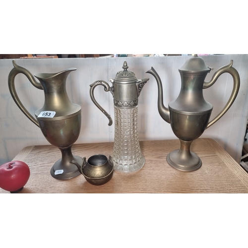 653 - Set of 4 antique metal pitchers and jug, including two tall pitchers, a glass and metal decanter, an... 