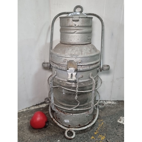 660 - Star Lot : Vintage metal ship's lantern, featuring a robust handle and protective cage, with hinged ... 