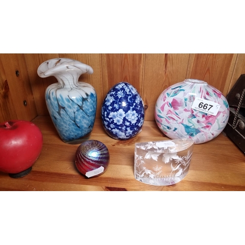 667 - Collection includes a white and blue vase, a blue floral egg, a pink and green vase, a red apple, an... 