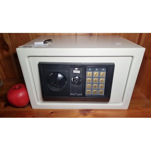 673 - Digital electronic safe with keypad and key override. Compact design with interior lining and secure... 