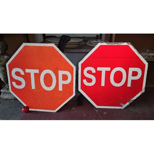 687 - Two vintage octagonal signs. Feature reflective red and orange backgrounds with 