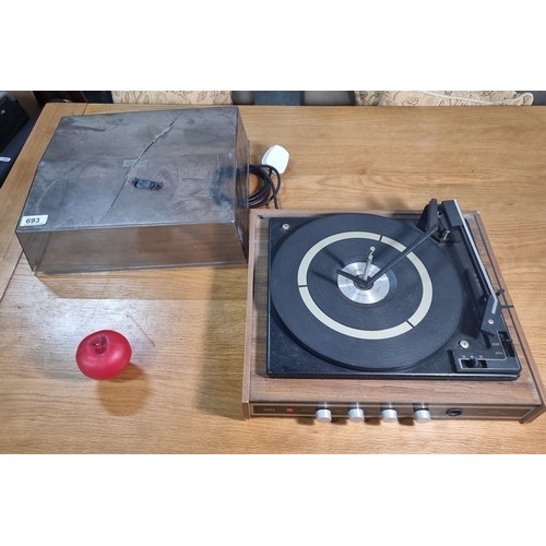 693 - Vintage BSR record player with plastic dust cover. Crafted in Great Britain, it features standard co... 