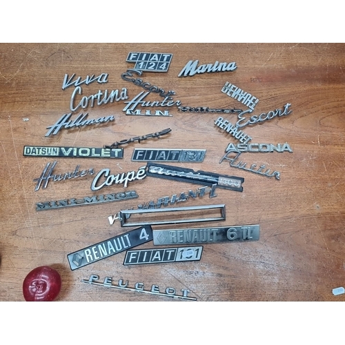 728 - 24 vintage car badges featuring brands like Fiat, Cortina, Hunter, Mini Minor, Datsun, Renault, Asco... 