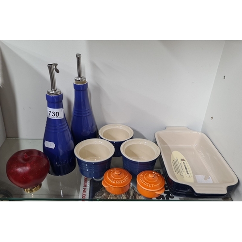 730 - Le Creuset stoneware set, includes two blue oil bottles, three blue ramekins, one stoneware baking d... 