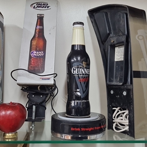 734 - Includes Bud Light and Guinness beer branded pub tap handles and displays, featuring one Guinness Dr... 