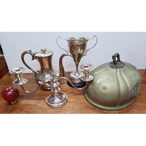 738 - Assorted silver-plated tea set including teapot, trophy cup, two-arm candelabra, and decorative cloc... 