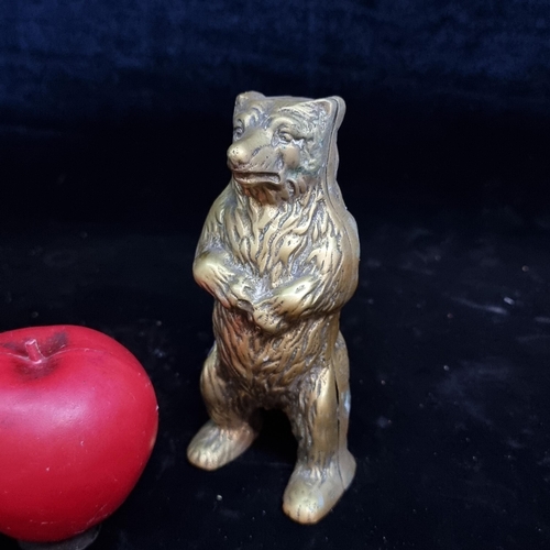 205 - A heavy vintage cast brass money bank in the form of a bear.