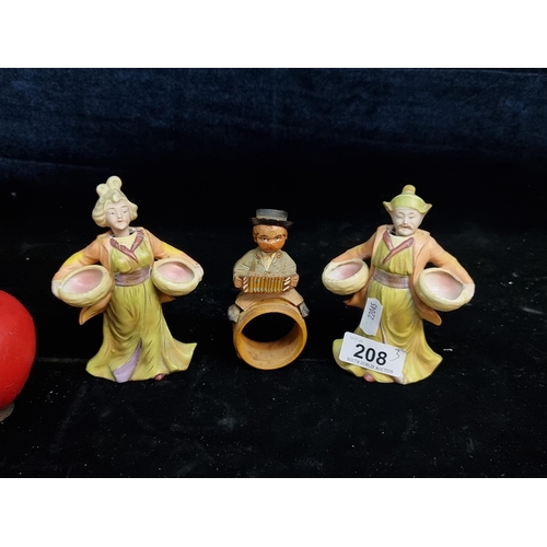 208 - A pair of characterful Chinese 'nodding head' porcelain figures along with a carved wood napkin ring... 