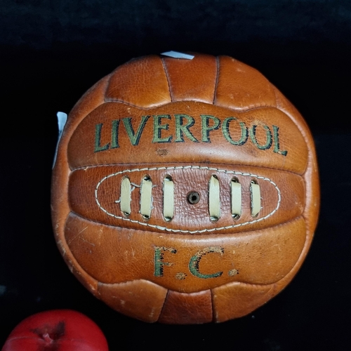 221 - A vintage leather football with text reading Liverpool F.C to front.