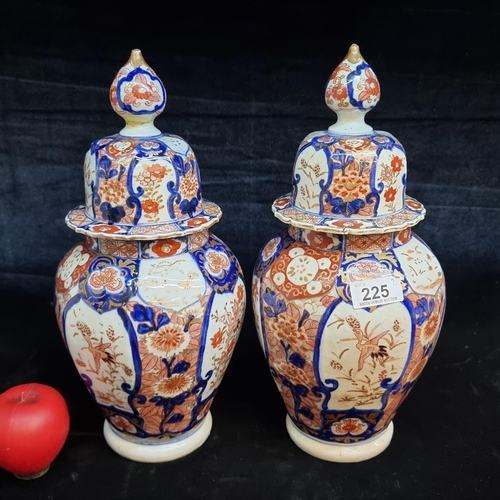 225 - Star Lot : A striking pair of tall vintage  Japanese Imari lidded vases. Lovely colours and in good ... 