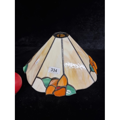 334 - A pretty example of a Tiffany style beige lamp shade with green and orange accents.