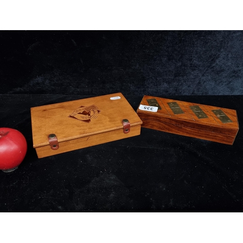 335 - A vintage dominoes game set housed in a wooden case with brass accents along with a wooden case cont... 