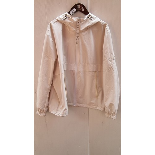 371 - A stylish Tommy Hilfiger TH Protect cream soft shell rain jacket with adjustable elasticated pull on... 