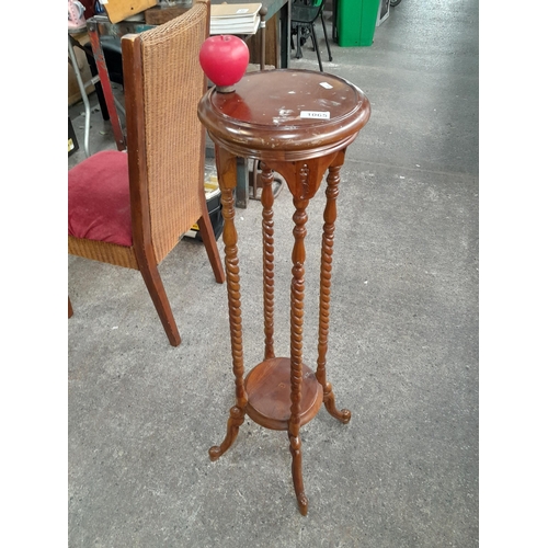 1065 - A tall mid century style plant stand featuring barley twist detail with cabriole legs.