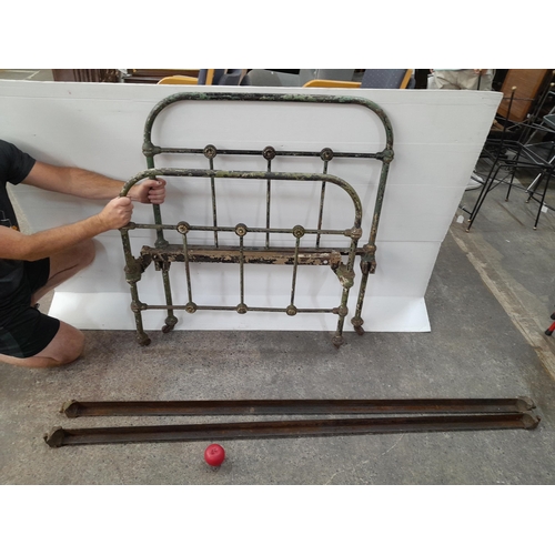 1160 - A lovely rustic antique heavy cast iron bed frame on castor wheels. Very heavy weight, Header, foote... 