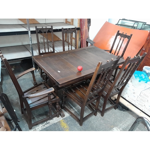 1175 - Star lot : A solid well made early 20th Century ercol dining table along with six matching dinning c... 