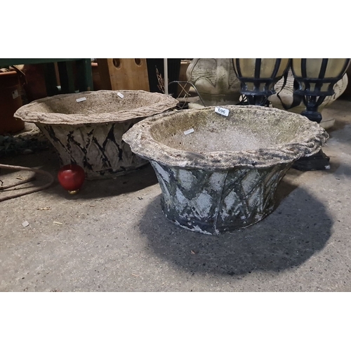 696 - Star Lot : Pair of large vintage stone planters, featuring a classic flared design with a diamond pa... 