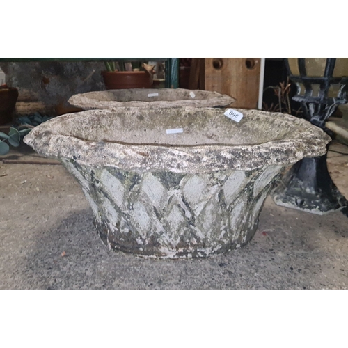 696 - Star Lot : Pair of large vintage stone planters, featuring a classic flared design with a diamond pa... 