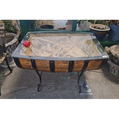 699 - Star Lot : Upcycled half whiskey barrel glass-topped coffee table with iron supports. Rustic appeal.... 