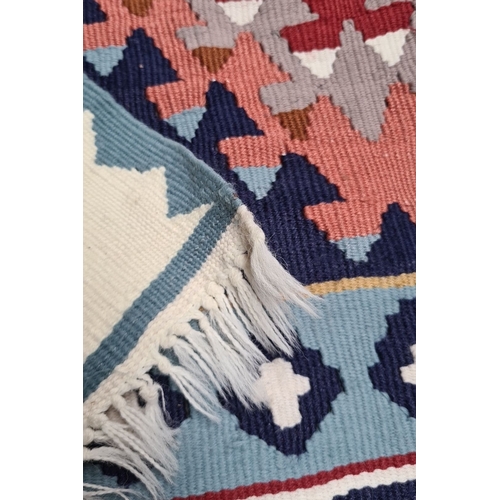 251 - Star Lot : A hand knotted Kilim Rug with geometric patterns in vibrant colors—blues, reds, and white... 