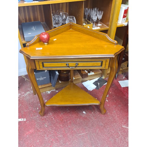 439 - A stylish mid century style corner table. Features a nicely sized pull out drawer to front, brass ha... 