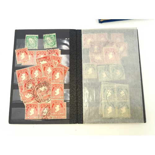 1185 - Two small stock albums both with Irish definitives first and second issue used. E Watermark with app... 