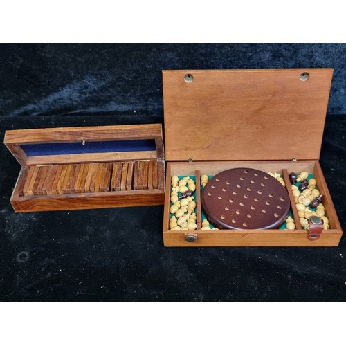 335 - A vintage dominoes game set housed in a wooden case with brass accents along with a wooden case cont... 