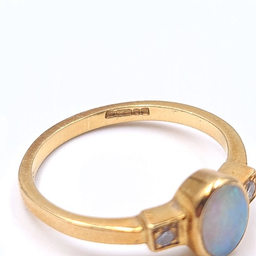 3 - Star Lot : A pretty opal and diamond ring set in 18 carat gold. Ring size K. Weight 2.59 grams.