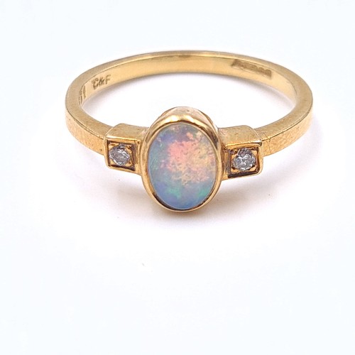 3 - Star Lot : A pretty opal and diamond ring set in 18 carat gold. Ring size K. Weight 2.59 grams.