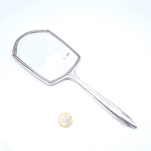 12 - A sterling silver hand mirror with bevelled glazed mirror. Hallmarks indistinct. Dimensions 26cm L /... 