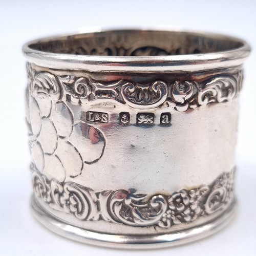 501 - A sterling silver repoussé designed napkin ring. Hallmarked Birmingham. Weight 25.48 grams.